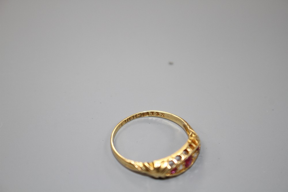 A George V 18ct gold, three stone ruby and two stone diamond set half hoop ring, size P, gross weight 1.9 grams.